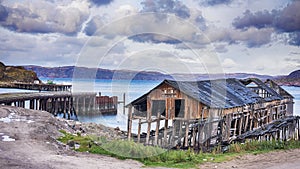 Pier and water line in village Teriberka, Russia