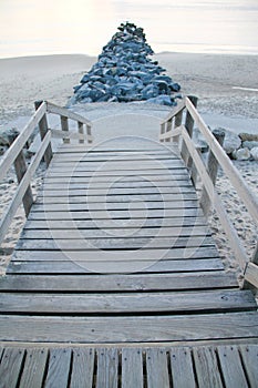 Pier wooden stone access sandy beach pontoon on Lacanau Ocean in Gironde france