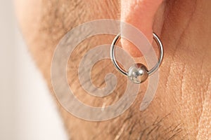 Pierced ear of a man