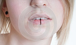 Pierced female lips with vertical labret piercing or lip ring photo