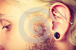 Pierced man ear, black plug tunnel, industrial and rook