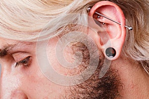 Pierced man ear, black plug tunnel, industrial and rook