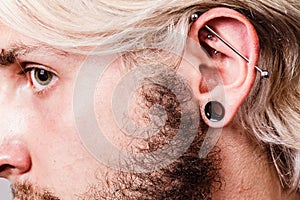 Pierced man ear, black plug tunnel, industrial and rook