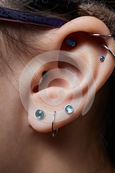 piercings on an ear. Conch and helix piercings close up.