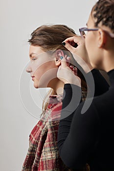 piercings on an ear. Conch and helix piercings close up.