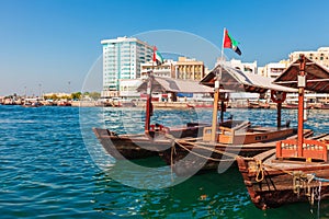 Piers of traditional water taxi boats in Dubai, UAE. Panoramic view on Creek gulf and Deira area. Famous tourist destination