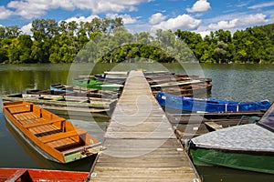 Piert and old boats in the river of Tisza at Martely