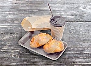 Pies with cottage cheese and tea in paper cup