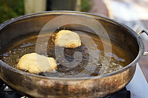 Pies frying in hot oil