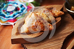 Pies samosas with vegetables on a wooden board still life in