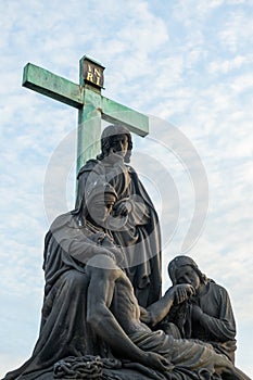 Pieta, Lamentation of Christ statue on Charles Bridge in Prague, Czech Republic. Medieval Gothic bridge, finished in the 15th photo