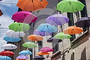 Pietrasanta, Lucca: the main street with colorful umbrellas