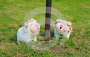 Pig clay doll on green.