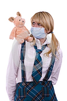 Pig flu virus.Schoolgirl with mask is afraid pig