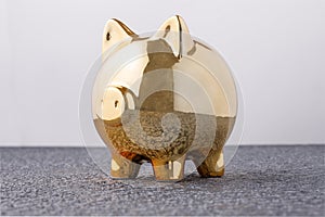Pig money box golden on black background concept of financial insurance, protection, safe investment or banking