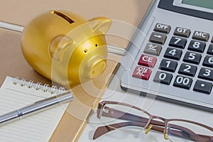 Pig piggy bank, calculator, phone, notebook, pen, glasses, concept of saving money.