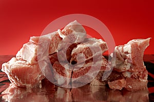 Pig, pork raw meat pieces over red