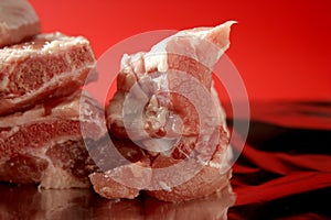 Pig, pork raw meat pieces over red