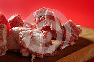 Pig, pork raw meat pieces over red