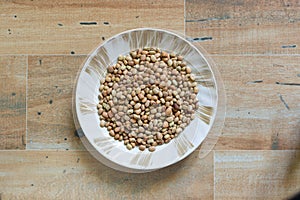 Pigeon pea or red gram on a side dish plate wooden background