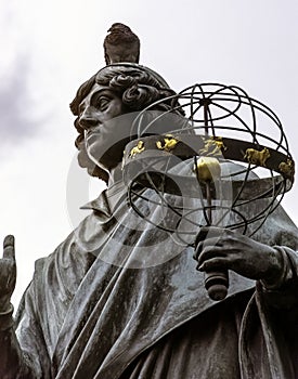 Pigeon sitting on Copernicus head