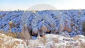 Pigeon valley with snowy landscape in winter in Cappadocia, Turkey