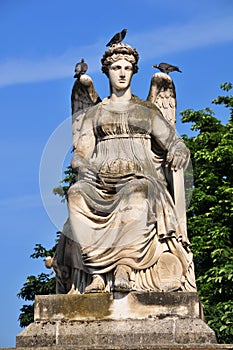 Pigeons on angel sculpture in Jardin des Tuileries, Paris, France photo