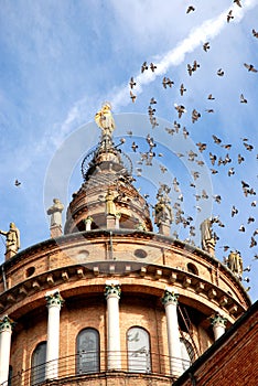 Pigeons in flight above the church