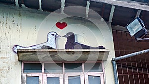 Pigeons imitating wallpainting on building