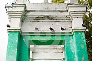 Pigeons perched on top of the gate arch