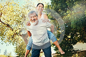 Piggy back, portrait and Asian couple in garden for bonding, healthy relationship and relaxing outdoors. Marriage