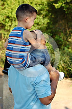 Piggy back ride father and son