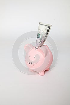 Piggy Bank with $5 sticking out