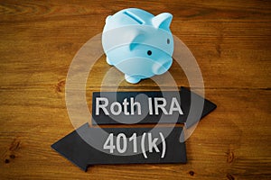 Piggy bank and arrows with signs Roth IRA and 401k retirement plan.