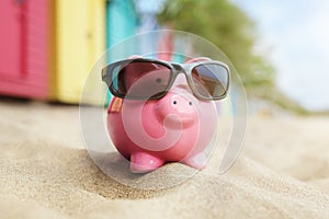 Piggy bank on beach vacation