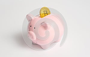 Piggy bank with a bitcoin coin