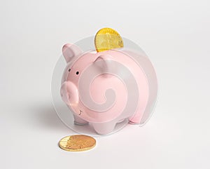 Piggy bank with a bitcoin coin