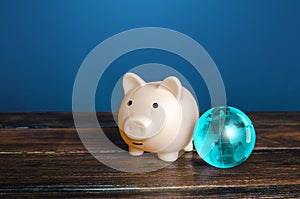 Piggy bank and blue earth globe. World financial system. Payment services, international money transfers. financial flows.