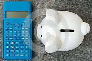 Piggy bank and blue modern calculator