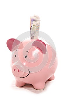 Piggy bank with British currency notes