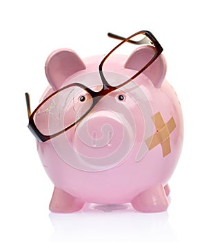 Piggy bank with broken eyeglasses