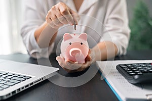 Piggy bank with business stuff, business and finance concept. Business diagram on financial report with coins. Investment results