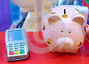 Piggy bank and cash terminal for paying for purchases in the store. Financial concept