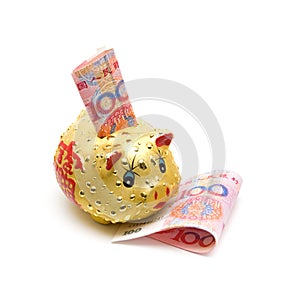 Piggy bank and Chinese yuan note isolated on white background