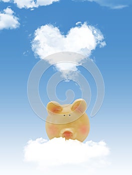 Piggy bank on cloud with heart shape cloud and blue sky