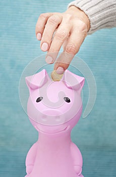 Piggy bank coin and hand