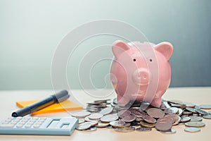 Piggy bank with coin note paper and calculator for personal account money saving concept photo