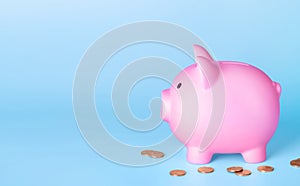 Piggy bank and coins money on blue background. Finance saving concept