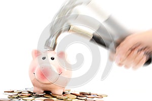 Piggy bank crashed or braked by hammer on money pile suggesting financial crisis photo
