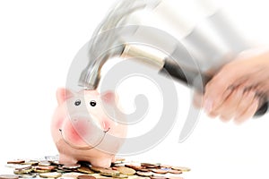 Piggy bank crashed or braked by hammer on money pile suggesting financial crisis photo